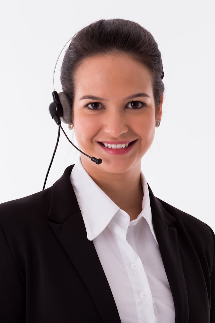 Confident female call center agent smiling at the camera with a headset.